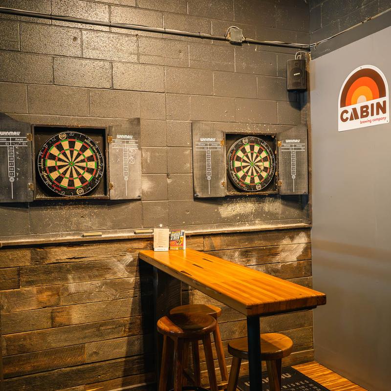 Dart boards and reclaimed wood — games area at The Royal